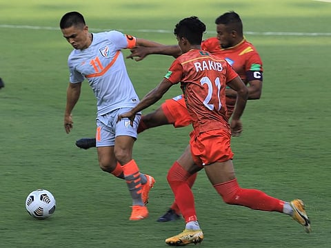 Indian captain Sunil Chhetri (white) proves unstoppable for two Bangladesh players during their Fifa World Cup Qualifier in Doha on Monday.