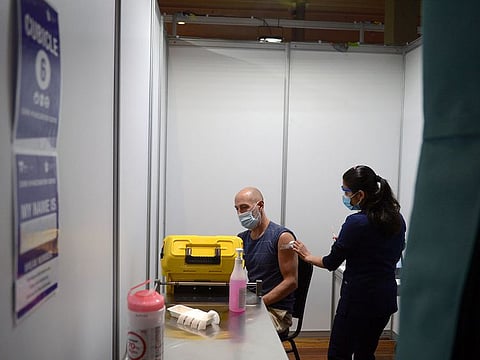 A health worker administers a dose of Covid-19 vaccine at a vaccination center set up at the Royal Melbourne Exhibition Centre in Melbourne, Australia, on Tuesay, June 8, 2021.