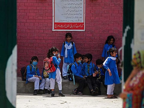 Students wait under a shade for transport at a school on a hot summer day in this file photo from Rawalpindi.