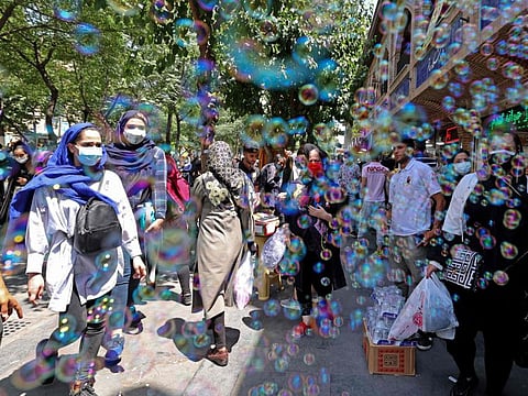 Iranians shop at the Grand Bazaar of Iran's capital Tehran on June 9, 2021. When Iranians vote for a new president next week, they will do so in the depths of an economic crisis brought on by crippling sanctions and worsened by the pandemic.