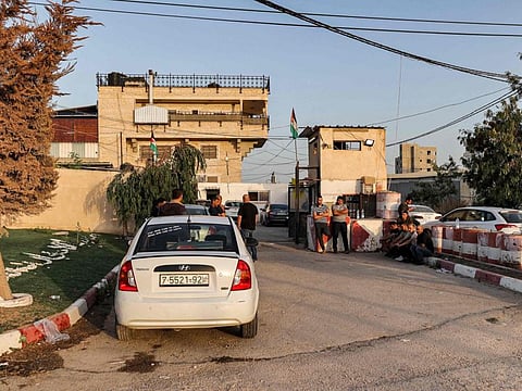 People wait outside the Palestinian military intelligence security service headquarters in Jenin where the shoot out took place on Thursday.