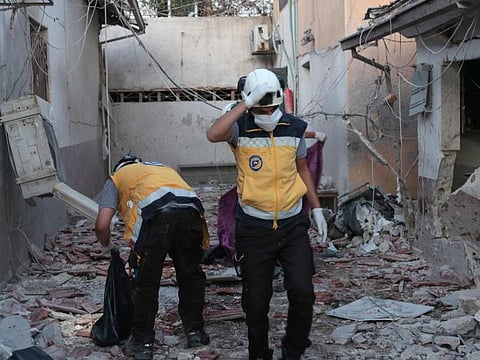Members of Syria's Civil Defence service (White Helmets) sift through the rubble at Al Shifaa hospital following shelling of the rebel-held city of Afrin in northern Syria, on June 12.