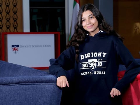 Malak Bilbesi in the hoodie she designed