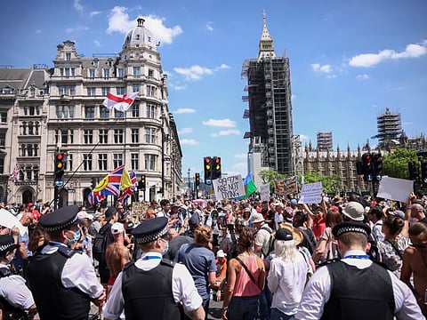 People gather during an anti-lockdown and anti-vaccine protest near the Houses of Parliament in London on June 14.