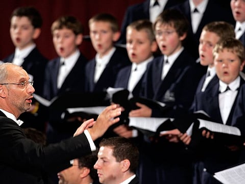 In this Thursday, Oct. 20, 2005 file photo, Regensburg Cathedral Choir, director Roland Buchner, left, conducts, during a concert dedicated to Pope Benedict XVI in Paul VI hall at the Vatican.