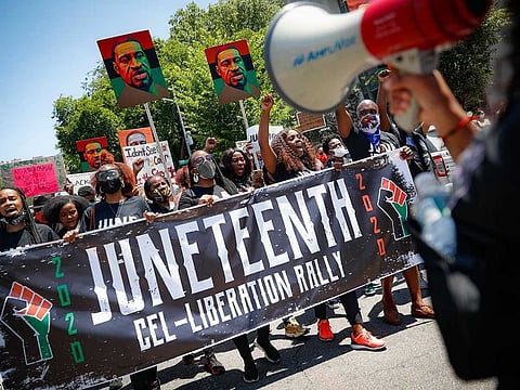 In this file photo, protesters chant as they march after a Juneteenth rally at the Brooklyn Museum, in the Brooklyn borough of New York