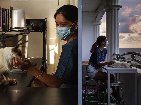 Tanya Mariano with her pet cat at her apartment in the town of San Juan, La Union province, north of Manila.