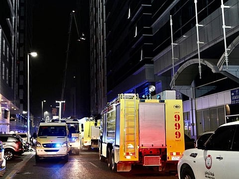 Fire engines from Abu Dhabi Civil Defence conducting firefighting operations at the building in Al Maamoura area on Thursday night.