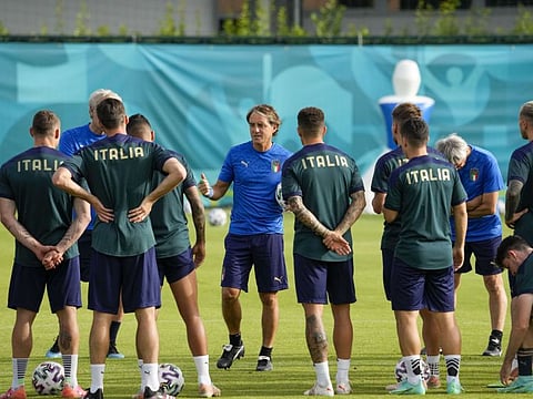 Italy's manager Roberto Mancini talks to his players during a team training session at Rome's Acqua Acetosa training center before their Euro 2020 championship Group A match against Wales today.