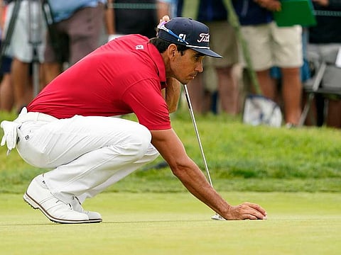 Rafa Cabrera Bello lines up a putt on the second green during the third round of the US Open golf tournament at Torrey Pines Golf Course.