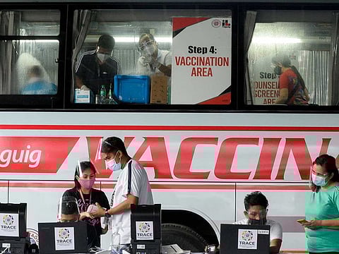 Health workers encode information and prepare vaccines against the coronavirus disease (COVID-19) at a mobile vaccination site in Taguig, Metro Manila, Philippines, in this file photo taken on May 21, 2021.