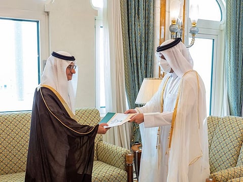 A handout picture released by the Qatar News Agency (QNA) shows Qatari Deputy Prime Minister and Minister of Foreign Affairs Sheikh Mohammed Bin Abdulrahman Al Thani (right) receiving a copy of the credentials of the Ambassador of Saudi Arabia Prince Mansour bin Khalid bin Farhan, in Doha on June 21, 2021.