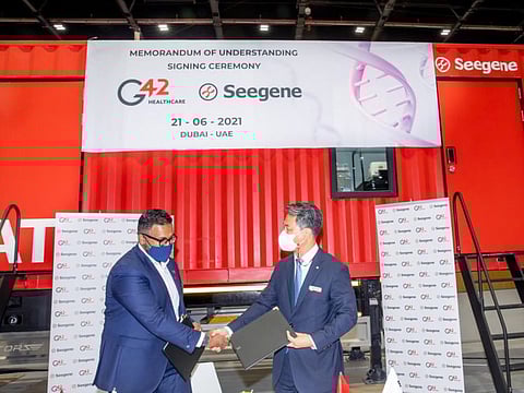Ashish Koshy, CEO of G42 Healthcare and James Park, Seegene Executive Director sign the agreement.