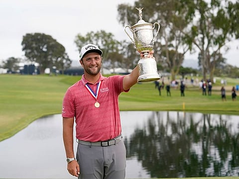 Jon Rahm, depending champion of US Open, with the winner's trophy at Torrey Pines last year.