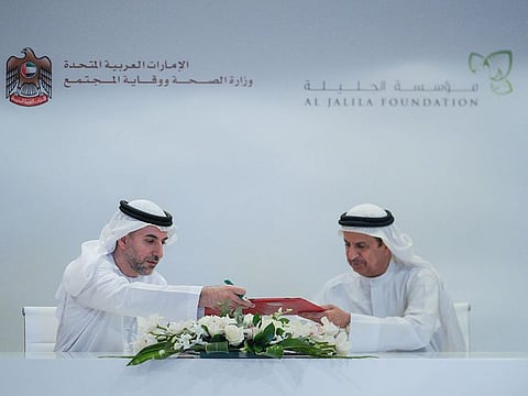 Dr Hussein Abdul Rahman Al Rand, Assistant Undersecretary of Health Centres and Clinics Sector (right) and Abdul Kareem Sultan Al Olama, Chief Executive Officer of Al Jalila Foundation, sign the agreement.