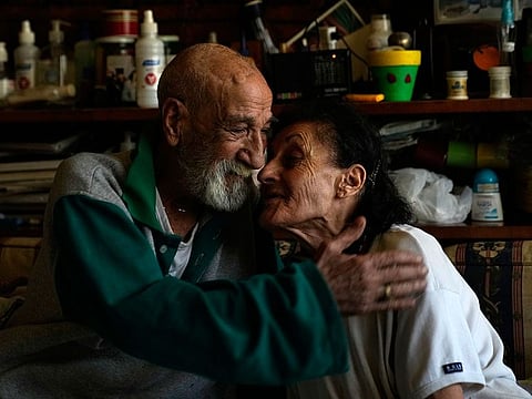 Marie Orfali, 76, and her husband Raymond, share a moment in their apartment in Beirut, Lebanon, Tuesday, June 15, 2021.
