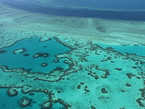 An aerial view of the Great Barrier Reef off the coast of the Whitsunday Islands, along the central coast of Queensland. Australia will strongly oppose a Unesco plan to list the Great Barrier Reef as "in danger" over its deterioration caused by climate change, the government said on June 22, 2021.