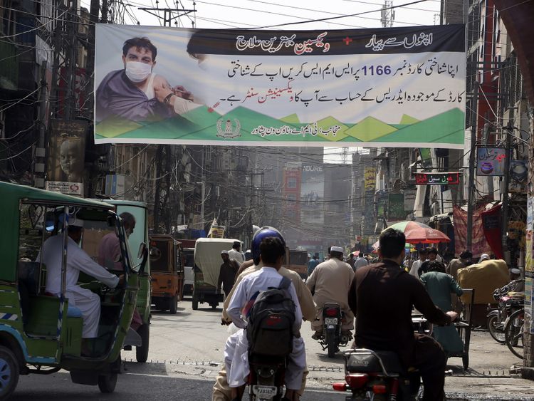 A banner explaining the COVID-19 vaccination process displayed to encourage people to get the jab in Peshawar.