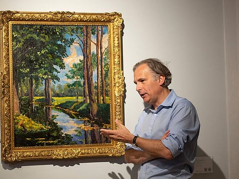 Jean Paul Engelen, Deputy Chairman and worldwide co-head of 20th century and contemporary art at Phillips Auction House speaks next to "The Moat, Breccles" painting made by Winston Churchill and owned by the Onassis family, in New York.