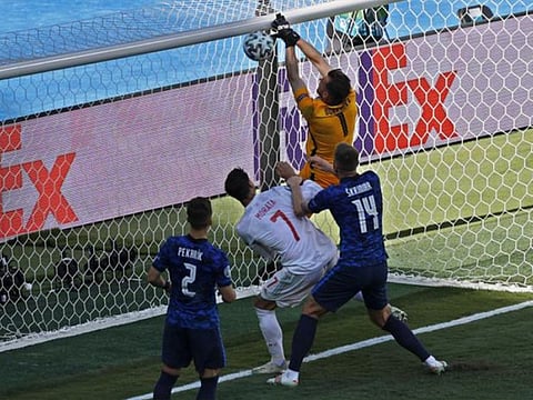 Slovakia's goalkeeper Martin Dubravka scores an own-goal while attempting to clear the ball during the Euro 2020 championship Group E against Spain at La Cartuja Stadium in Seville, Spain.