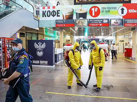 Workers from Russia’s emergency situations ministry spray disinfectant solution on the concourse during a deep clean operation at Leningradsky railway station in Moscow on June 24, 2021.