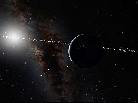 This illustration provided by the American Museum of Natural History depicts the planet Earth, with the Sun in the background. The line of spots across the center of the image indicates star systems which can see Earth as it goes in front of our Sun.