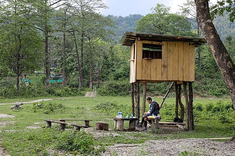 Bhutan's King Jigme Khesar Namgyel Wangchuck takes his lunch at a security outpost during his visit to remote villages to oversee measures to contain the spread of the coronavirus disease, in Tempaling, Bhutan.