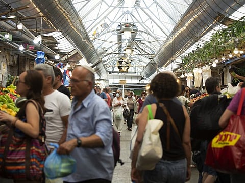 Shoppers, most them without masks, at the Mahane Yehuda market in Jerusalem on June 25, 2021.