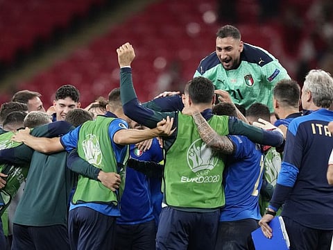 Italy's goalkeeper Gianluigi Donnarumma (top) celebrates with his teammates after they beat Austria in the Euro 2020 championship round of 16 match at Wembley stadium in London.