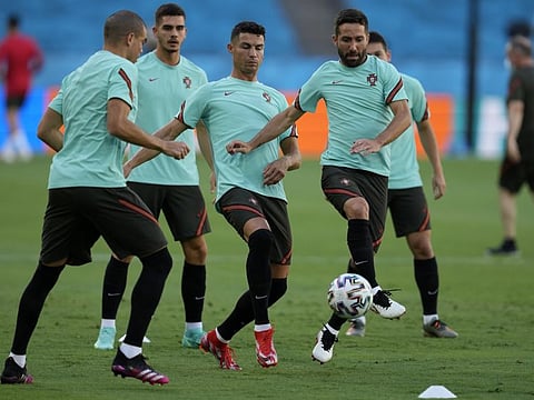 Portugal's Cristiano Ronaldo (centre) and Joao Moutinho (right) practice during a training session at the La Cartuja stadium in Seville, Spain ahead of their last 16 match against Belgium tonight.