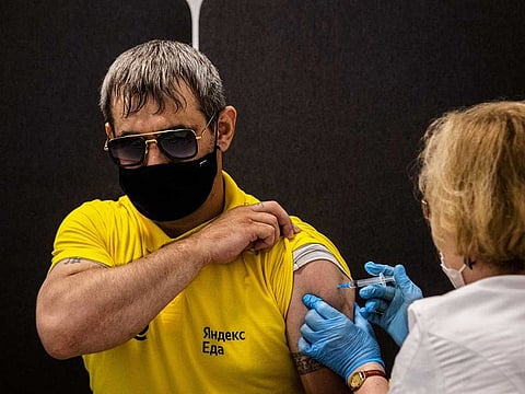 A man receives a dose of Russia's Sputnik V (Gam-COVID-Vac) vaccine a at a vaccination centre for the Yandex Go drivers and couriers in Moscow on June 25, 2021.