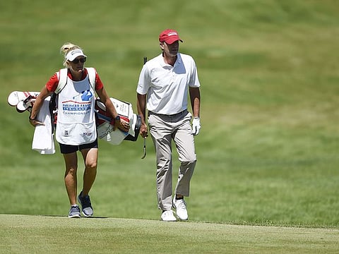 Steve Stricker walks to the 18th green with his caddie and wife Nicki Stricker