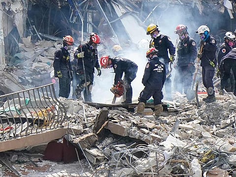 Crews work in the rubble at the Champlain Towers South Condo, in Surfside, Florida. Many people were still unaccounted for after Thursday's fatal collapse.