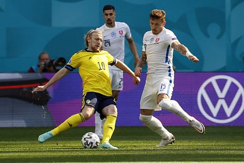Sweden's Emil Forsberg (left) in action against Slovakia. He has scored three times for the rock-solid Swedes and is fit to face Ukraine in the last 16 clash.