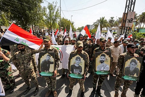 Members of Iraq's Hashed Al Shaabi (Popular Mobilisation) paramilitary forces march in a symbolic funerary parade in the capital Baghdad on June 29, 2021, in remembrance of those killed in a US raid against one of the Hashed's brigades.