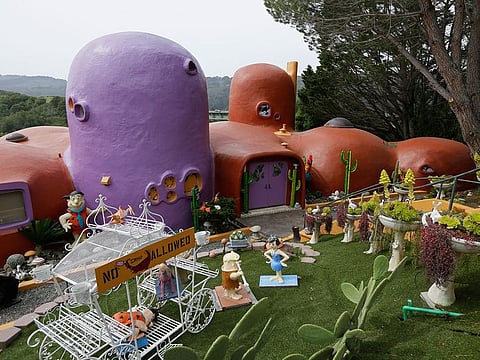 In this Thursday, April 11, 2019, file photo, The Flintstone House is seen before a news conference with the owner and the home's original architect in Hillsborough, California.