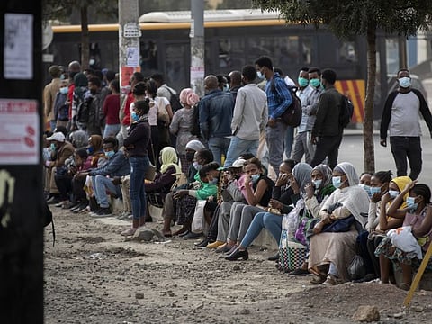 Ethiopians queue to catch a bus at a station in downtown Addis Ababa, Ethiopia, on June 18, 2021. Ethiopia’s federal government on Monday declared a “unilateral ceasefire” in Tigray, as rebel fighters entered the regional capital Mekele sparking celebrations in the streets.