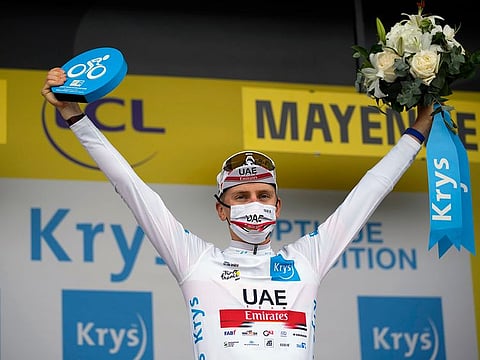 Slovenia’s Tadej Pogacar wears the best young rider’s white jersey on the podium of the fifth stage of the Tour de France cycling race in Laval Espace Mayenne, France, Wednesday, June 30, 2021.