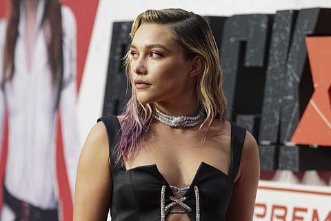 Florence Pugh poses for photographers upon arrival at a fan event for the film Black Widow in London, Tuesday, June 29, 2021.