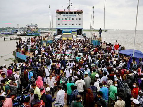 People board an overcrowded ferry as they go home a day before a countrywide lockdown is imposed, in Munshiganj, outskirts of Dhaka on June 30, 2021.