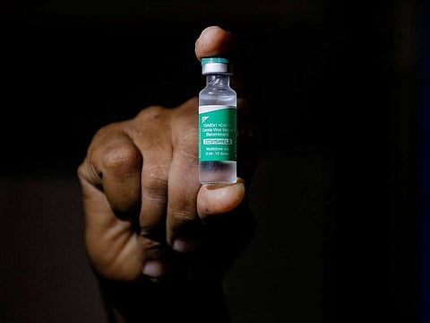 A man displays a vial of AstraZeneca's Covishield vaccine.