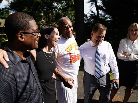 Bill Cosby, center, listens to members of his team speaks with members of the media outside Cosby's home in Elkins Park, Pa., Wednesday, June 30, 2021, after Pennsylvania's highest court overturned his sex assault conviction.
