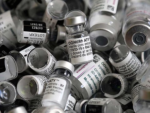 In this file photo dated Saturday, May 15, 2021, empty vials of the Pfizer-BioNTech COVID-19 vaccine lie in a box during a vaccine campaign at the Vaccine Village in Ebersberg near Munich, Germany.