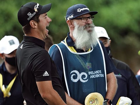 Lucas Herbert (left), who retained his lead after the second round, shares a lighter moment with his caddy at Dubai Duty Free Irish Open on Friday.