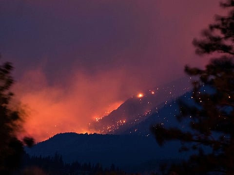 Wildfire burns above the Fraser River Valley near Lytton, British Columbia, Canada, on Friday, July 2, 2021. A protracted heatwave continues to fuel scores of wildfires in Canada’s western provinces.