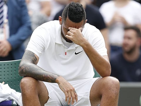 Australia's Nick Kyrgios reacts after losing his match by a walkover as he sustained an injury.