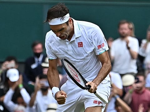 Switzerland's Roger Federer celebrates his victory over Britain's Cameron Norrie during their men's singles third round match on the sixth day of the 2021 Wimbledon Championships at The All England Tennis Club in Wimbledon, southwest London.