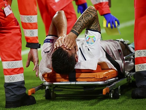 Italy's Leonardo Spinazzola covers his face after injuring during the Euro 2020 championship quarterfinal match against Belgium at at the Allianz Arena in Munich, Germany. He will miss the rest of the tournament and may be out for months.