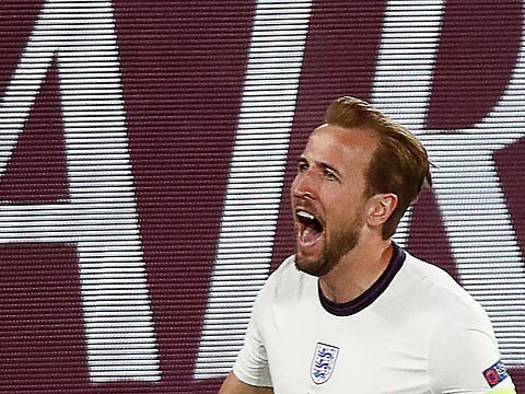 England's forward Harry Kane celebrates scoring the team's first goal during the quarter-final against Ukraine