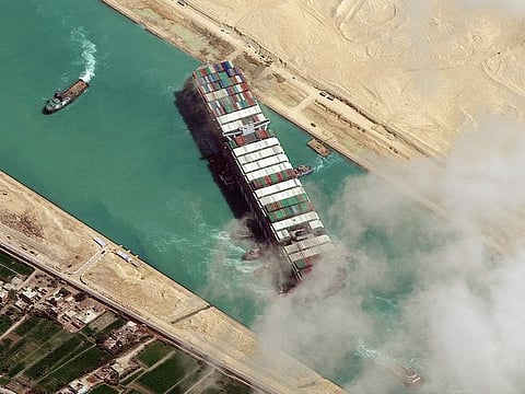 File photo: The MV Ever Given container ship being pushed by tugboats in the Suez Canal.